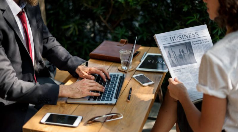 Modern journalist using multiple digital devices and platforms for news reporting