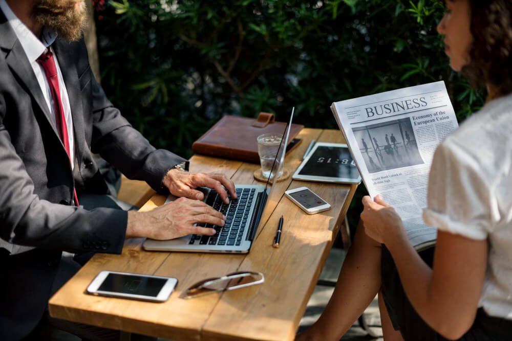 Modern journalist using multiple digital devices and platforms for news reporting
